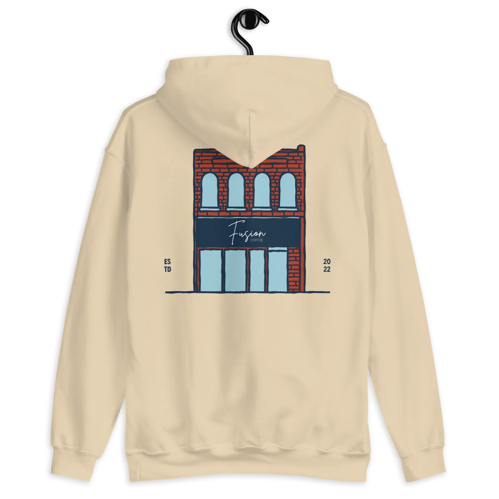 Sand-colored Fusion Coffee pullover hoodie with a back print of the brick storefront and navy “Fusion Coffee” sign, ESTD 2022.